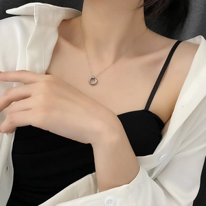 Minimalist silver geometric circle pendant necklace on a model with elegant metallic finish