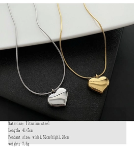 Detailed view of titanium steel heart pendant necklace showing gold and silver finish options