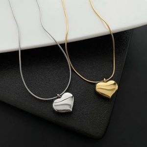 Minimalist gold and silver heart necklaces with polished finish and sleek snake chains