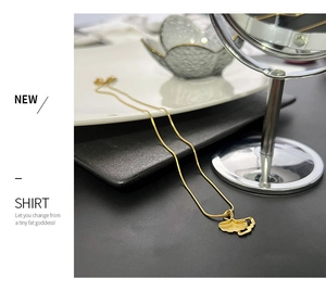 Detailed macro shot of golden ginkgo leaf pendant with delicate brushed metal texture