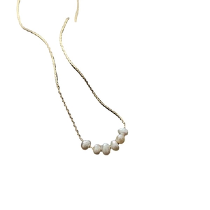 Elegant gold titanium necklace featuring six irregular natural freshwater pearls