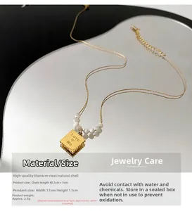 Detail view of square shell pendant with Love Me engraving and titanium steel chain