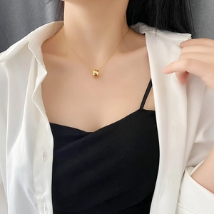 Minimalist gold titanium steel necklace featuring a geometric rhombus faceted pendant on neck