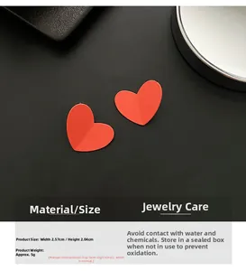 Detailed view of red matte heart earrings with dimensions 2.57cm wide and 2.04cm high