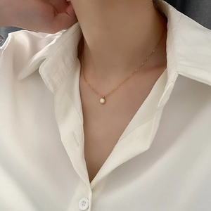 Elegant gold titanium steel necklace with a minimalist round white mother-of-pearl pendant