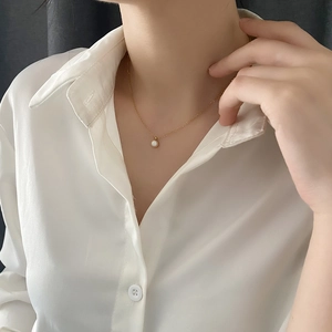 Minimalist gold necklace for women featuring a white shell pendant on a dainty chain
