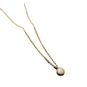 Elegant gold pendant necklace with iridescent opal center and vintage beaded edge on white