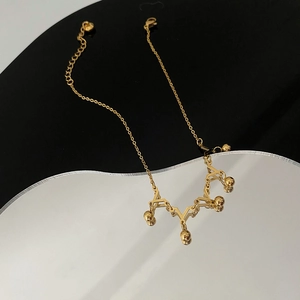 Golden crown-style anklet for women with elegant V-shaped charms and small gold beads