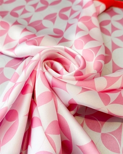 Detail view of pink and white floral pattern silk scarf with smooth satin texture