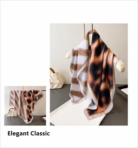 Detailed view of leopard print faux silk scarf with striped patterns and elegant borders