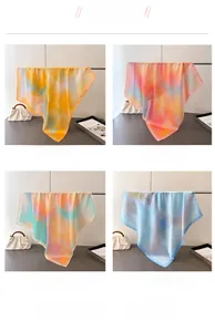 Detailed view of four gradient silk scarves in yellow, pink, mint green and blue hues