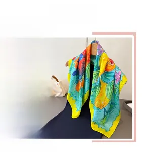 Close-up of vibrant floral and lemon print scarf with elegant silky texture