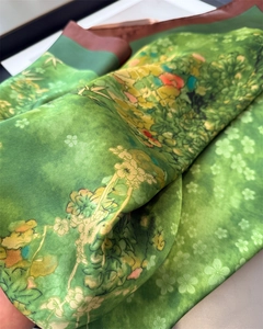 Detailed view of floral silk scarf featuring vibrant green fabric and delicate textures