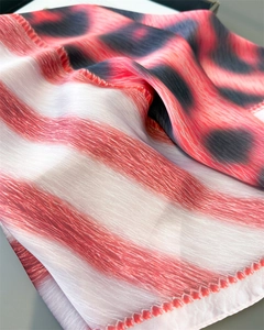 Macro shot of faux silk leopard print scarf showing striped texture and silky luster