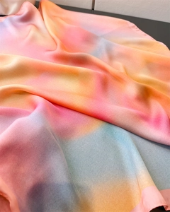 Macro shot of silk-satin scarf showing colorful gradient print and smooth texture