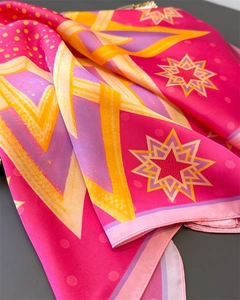 Detail view of colorful geometric star pattern on satin silk square scarf fabric