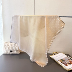 Detail of elegant champagne gradient silk scarf with grid pattern and white border
