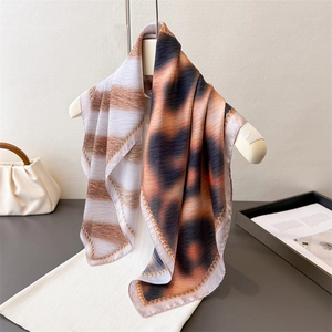 Luxurious leopard print faux silk scarf with gold wavy edges and elegant styling