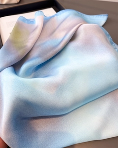 Close-up of elegant gradient blue and purple silk scarf with soft pearlescent luster