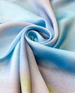 Macro shot of gradient silk satin fabric with soft blue and purple tones and glossy finish