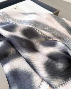 Close-up of leopard pattern silk scarf with gradient brushstrokes and hand-rolled edges
