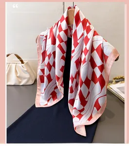Detail of red and white checkered silk scarf draped on a dress over a wooden hanger