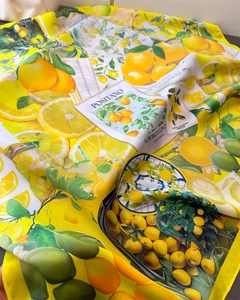 Detail view of lemon print satin scarf with Positano tile pattern and glossy fabric