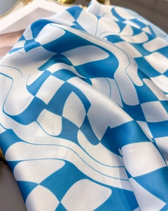 Detail of checkered sky blue satin scarf showing smooth glossy texture and wavy pattern