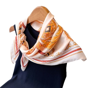 Satin silk scarf with chain print draped on a wooden hanger against a white background