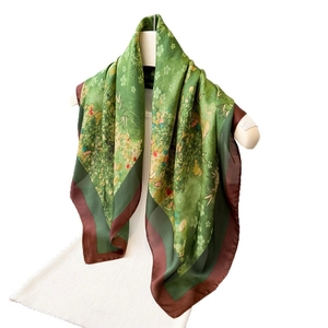 Elegant green silk-like square scarf with floral prints and dark brown contrast borders