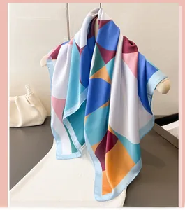 Detail of colorful geometric pattern silk scarf with soft satin finish and elegant drape