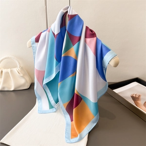 Elegant multi-color geometric silk scarf on hanger with premium satin finish
