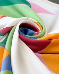 Macro shot of colorful geometric silk scarf with luxurious satin texture and vibrant prints