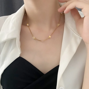 Elegant gold titanium steel necklace featuring crystal cube charms on a delicate chain