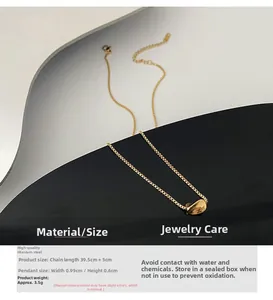 Detail of gold titanium steel necklace with irregular curved pendant and 39.5cm fine chain