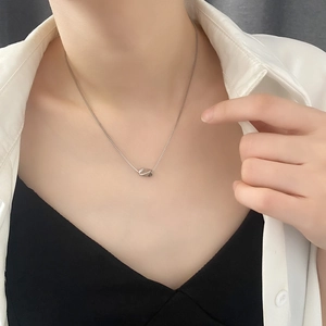 Elegant geometric titanium steel necklace with silver irregular pendant worn by model