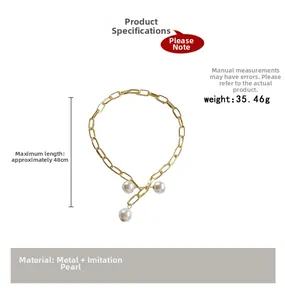 Detail showing chunky gold chain necklace length of 48cm and imitation pearl accents