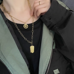 Gold double-layered stainless steel necklace featuring smiley and rectangular pendants