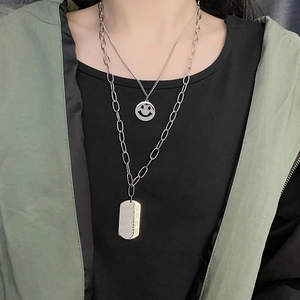 Double-layered silver steel necklace with smiley face charm and engraved winner tag