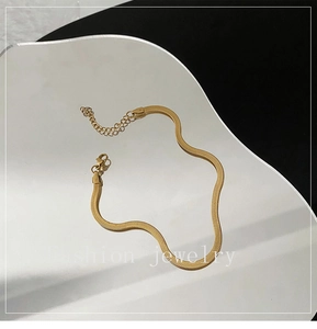 Detail of 18K gold snake bone anklet with lobster clasp and adjustable extension chain