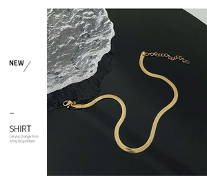 Detail of 18K gold herringbone snake chain anklet with lobster clasp and extender