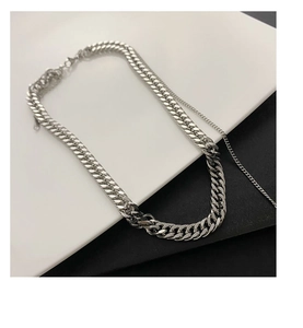 Detail of silver titanium steel chunky Cuban link chain with mixed texture design