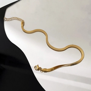 Elegant 18K gold snake chain anklet with lobster clasp on geometric mirror background