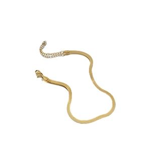 Classic 18K gold snake bone anklet with smooth metallic finish and lobster clasp