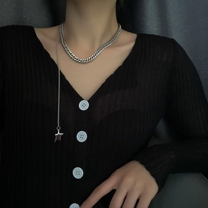 Silver titanium steel chunky Cuban necklace with star pendant on a model in V-neck knit