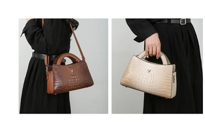 Detail of crocodile embossed pattern and V-logo on stylish tote bags in brown and beige