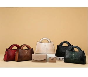 Detail view of crocodile pattern handbags in five colors with V-logo and matching wallets
