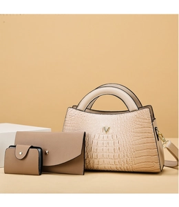 Three-piece beige faux leather bag set with crocodile texture and gold hardware detail