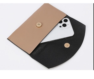 Close-up of two-tone flap bag with gold magnetic clasp and smartphone storage space