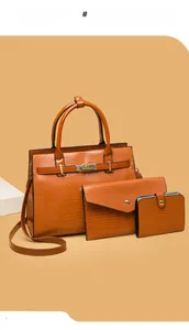 Detailed set of orange embossed leather handbag, envelope clutch, and small wallet
